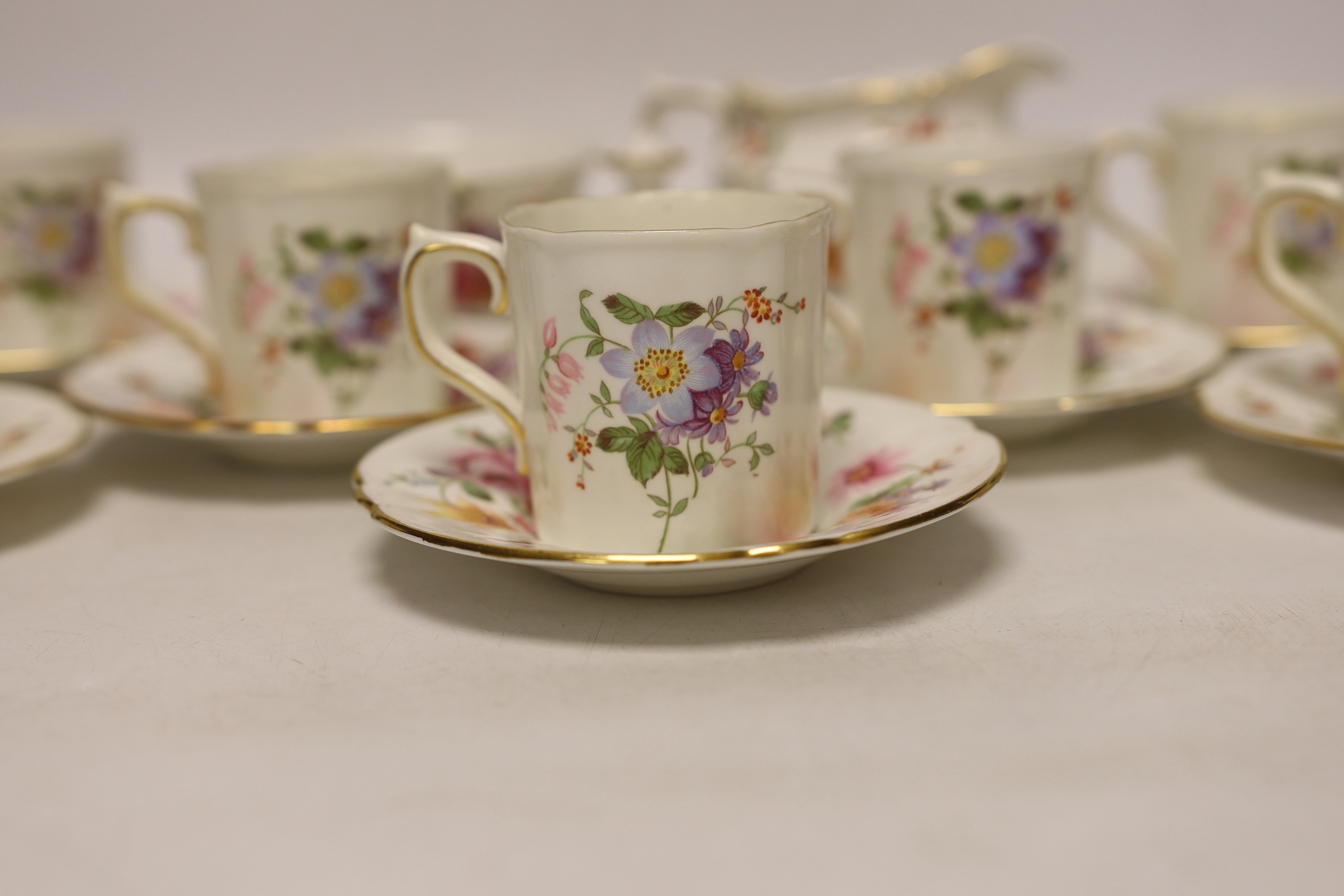 A Royal Crown Derby Posies coffee set comprising of seven cups and saucers, a sugar bowl and milk jug